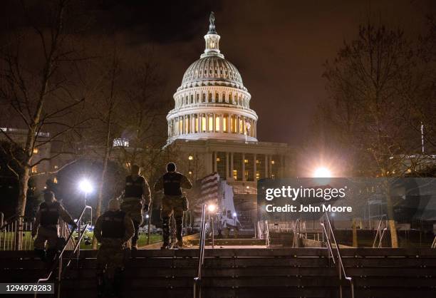 National Guard troops walk through the grounds of the U.S. Capitol on January 06, 2021 in Washington, DC. A pro-Trump mob stormed the Capitol...