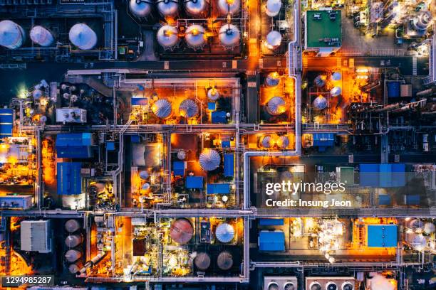 aerial view of oil refinery in petrochemical complex at night - petrochemical plant stock pictures, royalty-free photos & images