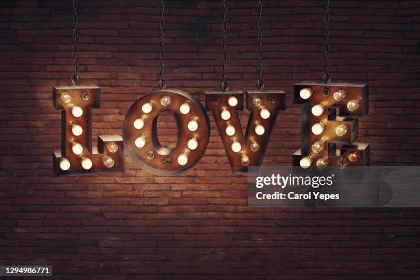 love word in light bulb text.retro style - rustic font stock pictures, royalty-free photos & images
