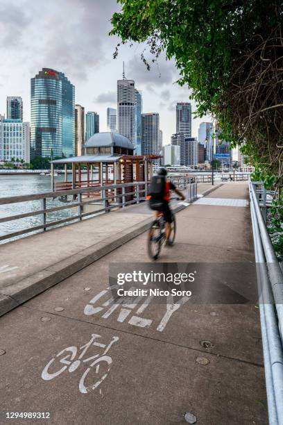 cyclist commuting to the city in brisbane - brisbane transport stock pictures, royalty-free photos & images