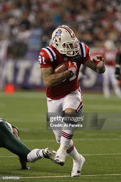 Tight end Aaron Hernandez of the New England Patriots makes a long gain against the New York Jets at Gillette Stadium on October 9, 2011 in Foxboro,...