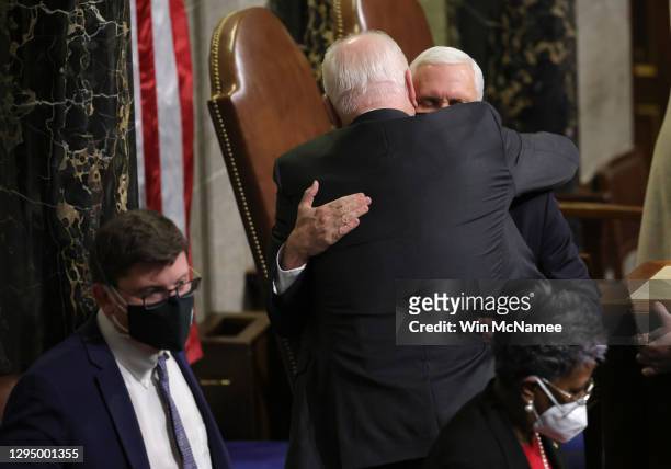 Vice President Mike Pence is hugged at the conclusion of the count of electoral votes in the House Chamber during a reconvening of a joint session of...
