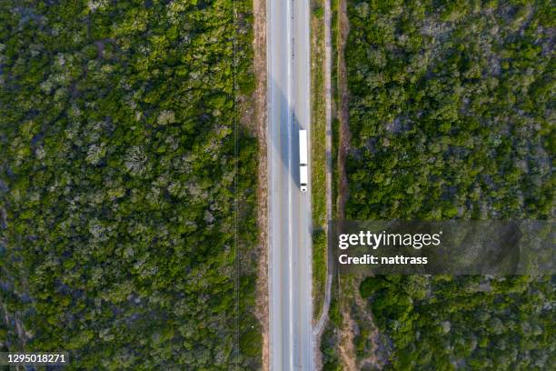 aerial view over a truck travelling down a road - truck birds eye stock pictures, royalty-free photos & images