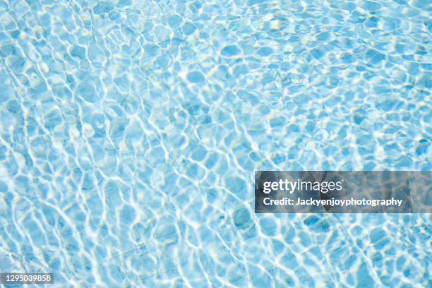 rippled water in the swimming pool - piscine photos et images de collection