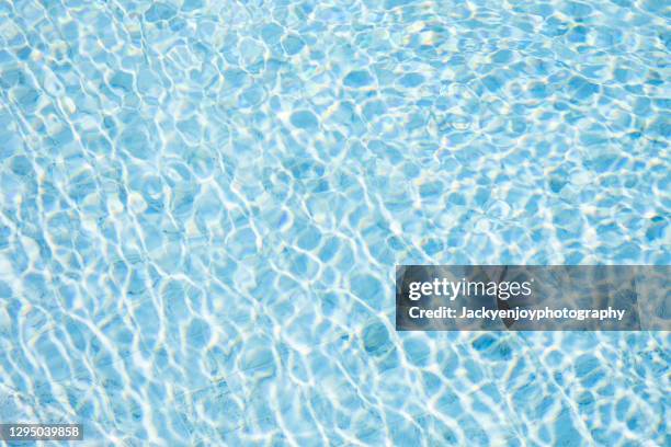 rippled water in the swimming pool - water surface pool stock pictures, royalty-free photos & images