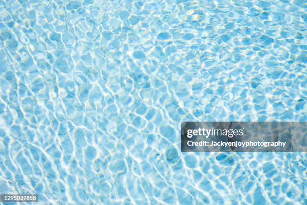 rippled water in the swimming pool - swimming pool texture stock pictures, royalty-free photos & images