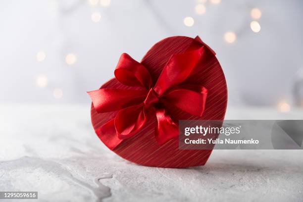 red gift box in shape of heart. the concept of valentine's day. - chocolate heart stockfoto's en -beelden