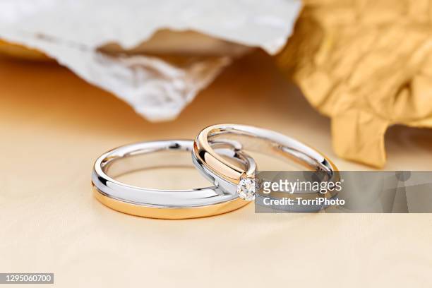 pair of unique wedding rings with diamond on female ring - white gold stock pictures, royalty-free photos & images