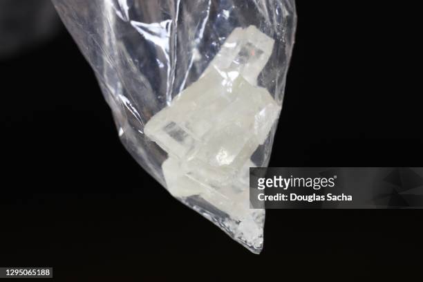individual bag of illegal synthetic drug on a black background - crack cocaine stock pictures, royalty-free photos & images