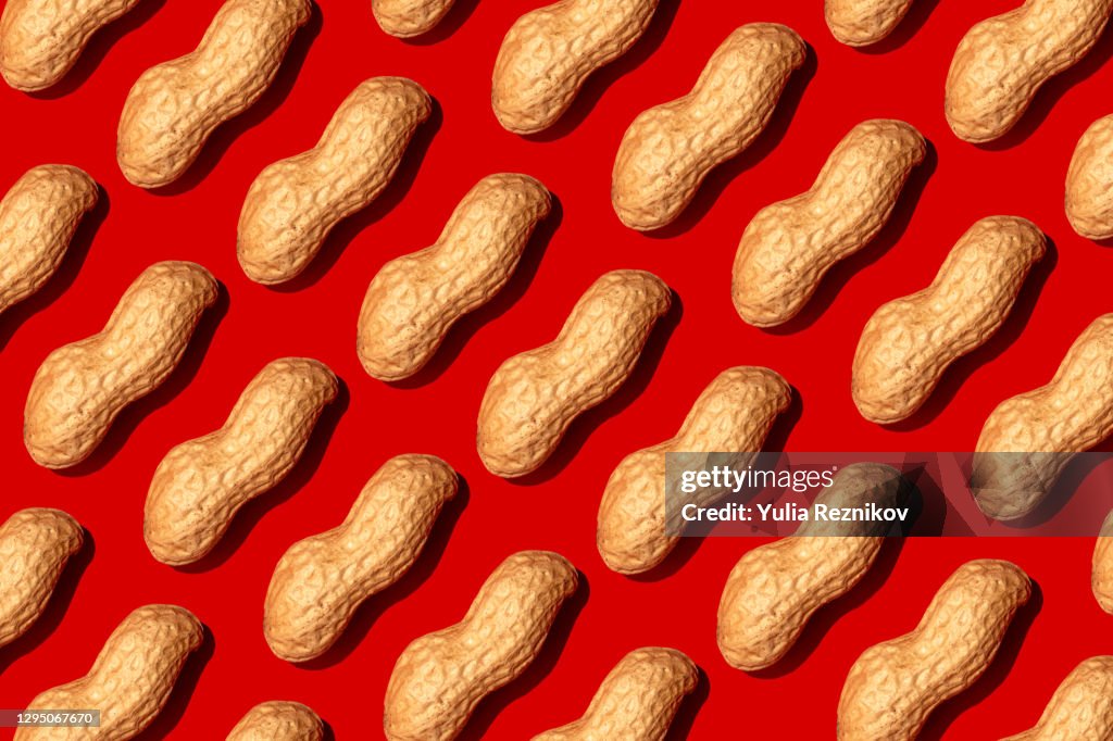 Repeated nuts on the red background