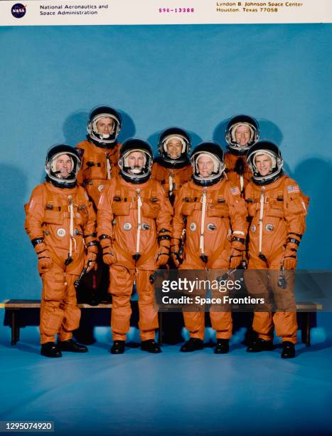 The crew of Space Shuttle Discovery , all wearing high altitude, partial pressure suits in a portrait ahead of shuttle mission STS-95 at Johnson...