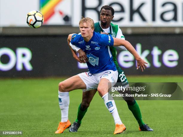 Molde's Erling Braut Haland holds off Hibernian's Efe Ambrose.