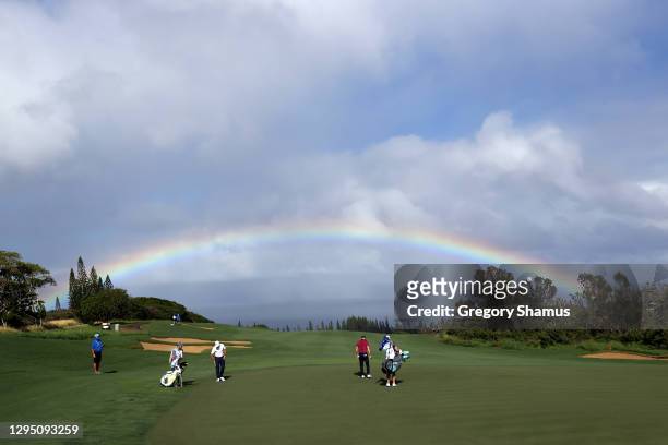 Rainbow is seen as Brian Gay of the United States walks on the fourth green during the first round of the Sentry Tournament Of Champions at the...