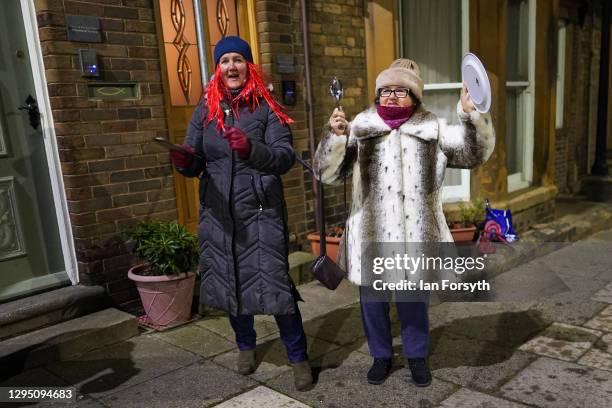 Mother and daughter stand outside their home in Saltburn and take part in the Clap for Heroes event on January 07, 2021 in Saltburn By The Sea,...