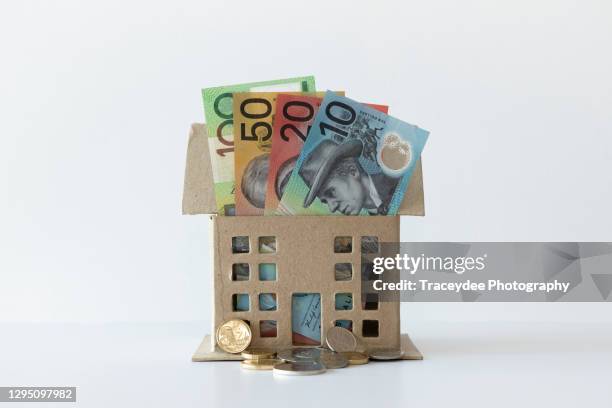 house containing some australian bank notes and coins. - renting stock pictures, royalty-free photos & images