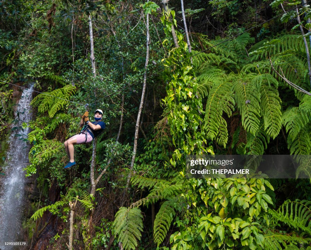 Zip line in Costa Rica against green foliage