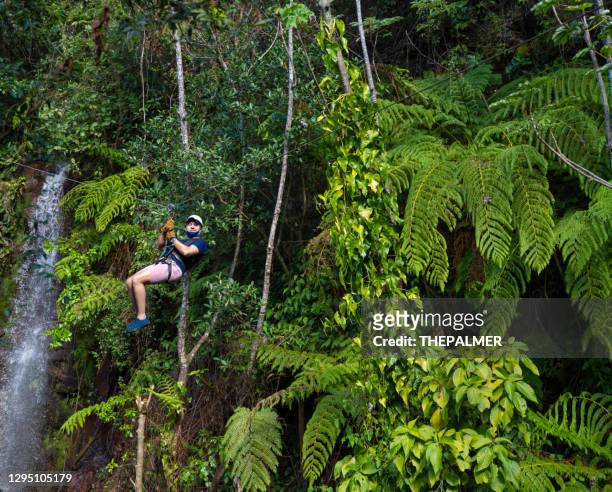 zip line in costa rica against green foliage - costa rica stock pictures, royalty-free photos & images