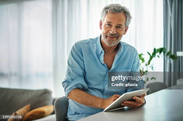 mid aged man staying at home during coronavirus quarantine. - 60 64 anos imagens e fotografias de stock
