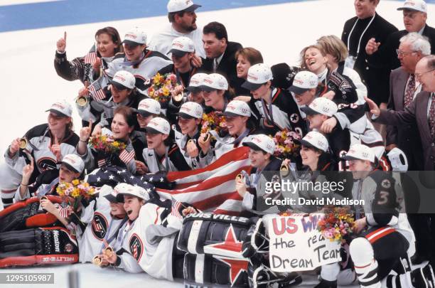 The USA Women's Ice Hockey team, coaches, and staff celebrate winning the Olympic gold medal match against Canada during the 1998 Winter Olympics on...