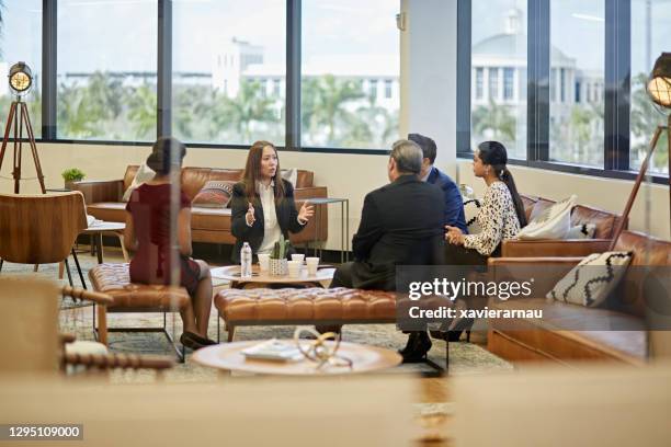 multi-ethnic group of executives discussing project plans - miami business stock pictures, royalty-free photos & images