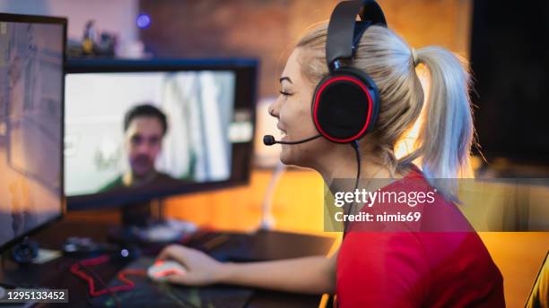 teenage girl playing multiplayer games on desktop pc in his dark room - massively multiplayer online game stock pictures, royalty-free photos & images