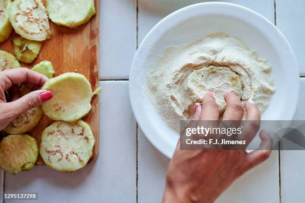 close-up of hands preparing eggplant dipped in egg and flour - breadcrumbs stock pictures, royalty-free photos & images