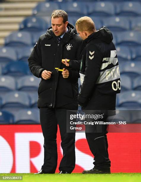 V VILLARREAL.IBROX - GLASGOW .A member of Rangers staff holds a firework that entered the field of play at full-time.