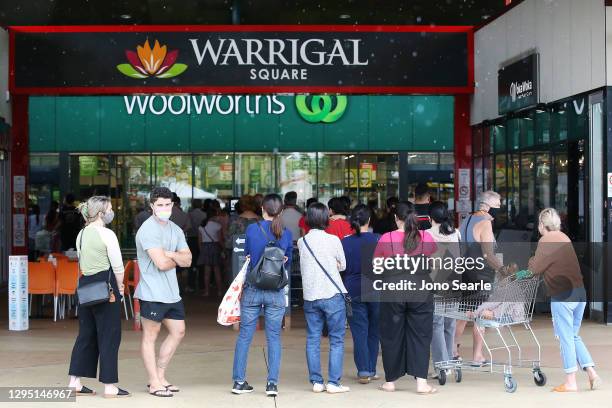 People stand in line outside a Woolworths at a southern suburb of Brisbane on January 08, 2021 in Brisbane, Australia. Brisbane will enter a...