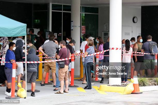 Local residents line up outside a 24-hour COVID testing clinic south of Brisbane, on January 08, 2021 in Brisbane, Australia. Brisbane will enter a...