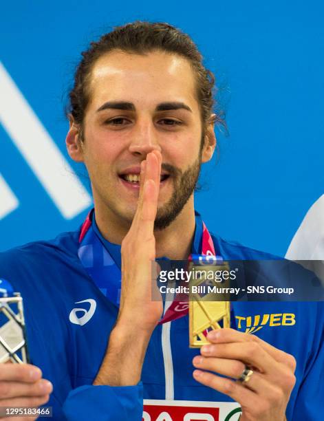 Italy's Gianmarco Tamberi collects his gold medal.