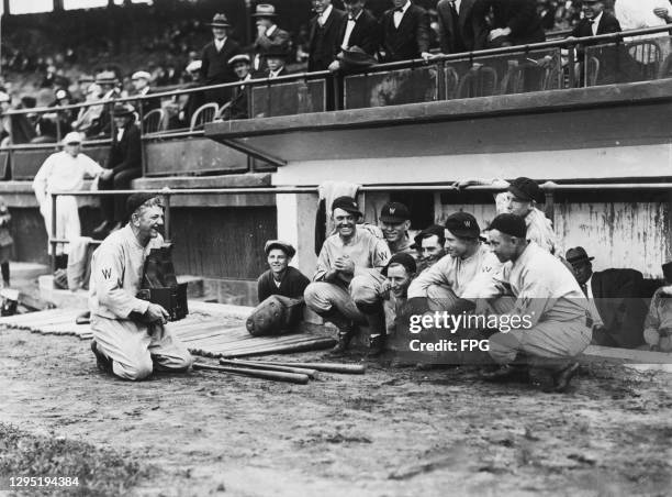 American baseball player Nick Altrock taking a photograph of his Washington Senators teammates at Fenway Park, a baseball park in Boston,...