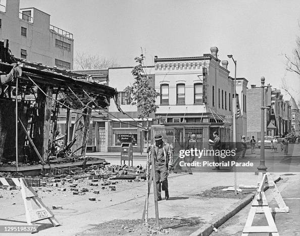 1968 Dc Riots Troops and pedestrians outside the burned out shell of a clothing ...