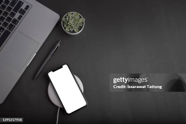 black office desk table with laptop,smartphone and supplies. top view with copy space, flat lay. - black top stock pictures, royalty-free photos & images