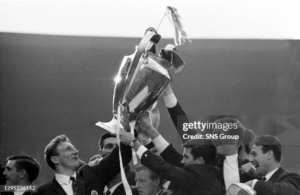 The delighted Celtic players show off the European Cup to their fans.