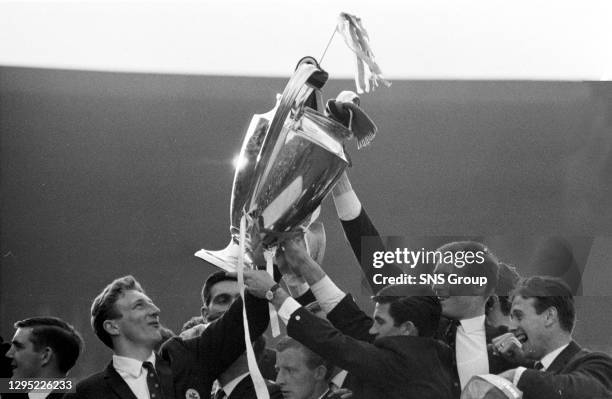 The delighted Celtic players show off the European Cup to their fans.