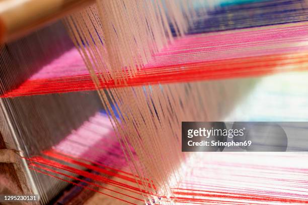 traditional silk weaving can be seen in the countryside of thailand. - weft stock pictures, royalty-free photos & images
