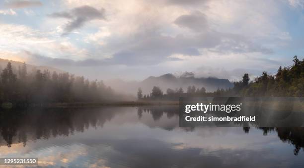 misty dawn at lake matheson, new zealand - mirror lake stock pictures, royalty-free photos & images