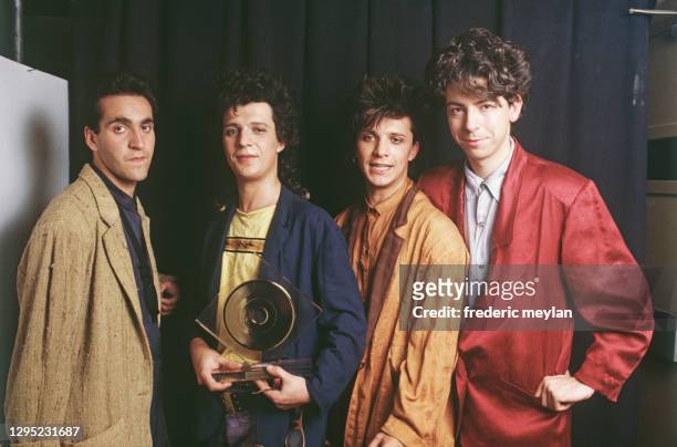 French band Indochine receives a Gold Record at Palais des Congrès in Paris, 24th October 1985. - From left to right : Dimitri Bodianski, Nicola...
