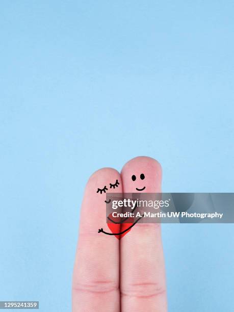 happy couple in love with a painted smile - embracing heart stock pictures, royalty-free photos & images