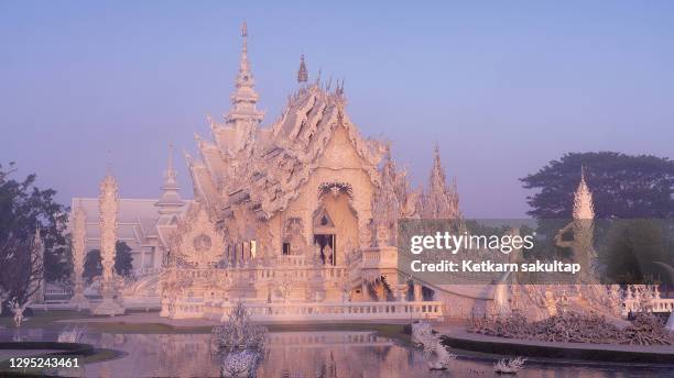 white temple (wat rong khun) in chiang rai province ad dawn. - wat rong khun stock pictures, royalty-free photos & images