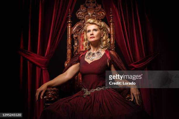 historical queen character on the throne - queen - royal person stock pictures, royalty-free photos & images