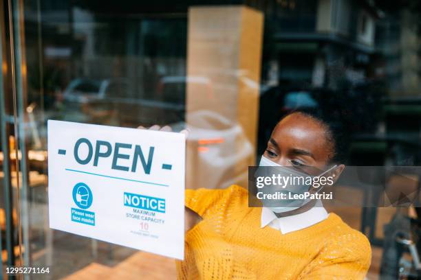 open sign in a small business store after covid-19 pandemic - store opening covid stock pictures, royalty-free photos & images