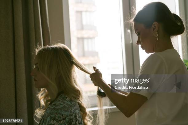 young girl doing hairstylehairstyle to a woman - hair extension stock pictures, royalty-free photos & images