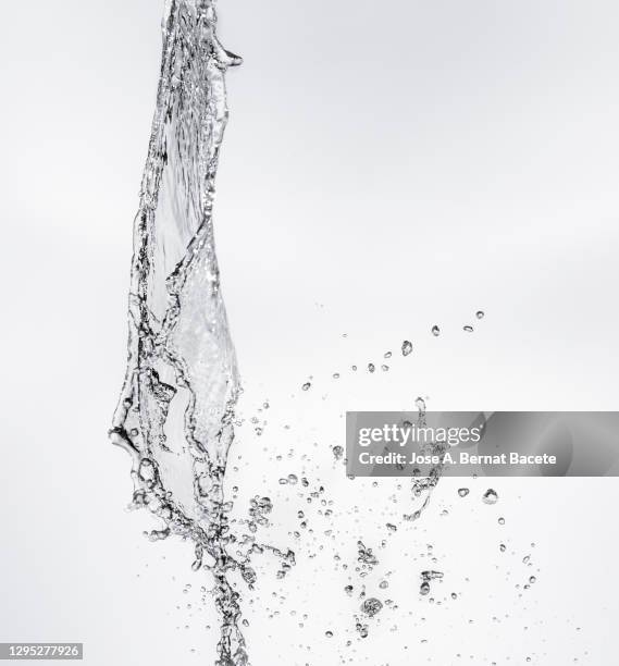 full frame of the textures formed  by the water jets to pressure with drops floating in the air on a white background - flowing stream stock pictures, royalty-free photos & images