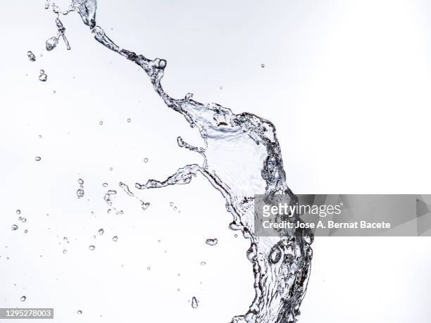 full frame of the textures formed  by the water jets to pressure with drops floating in the air on a white background - spray stock pictures, royalty-free photos & images