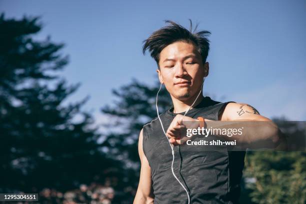 chinese men jogging in the city - male active lifestyle stock pictures, royalty-free photos & images