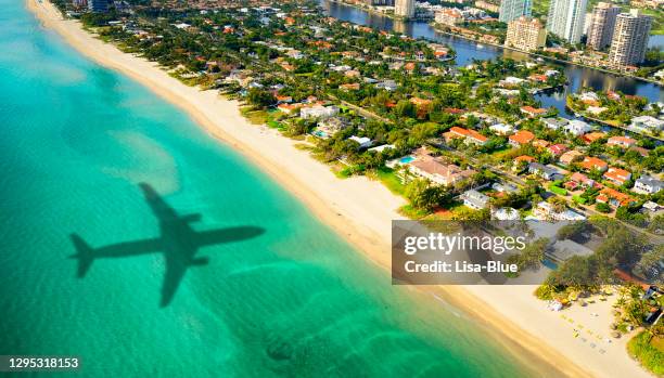 airplane shadow over miami. - miami stock pictures, royalty-free photos & images