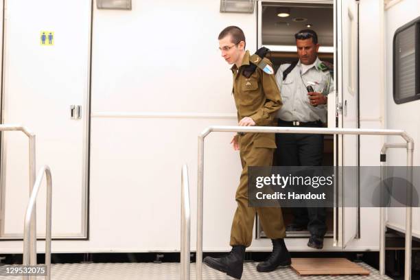 In this handout photo provided by the Israeli Defence Force, freed Israeli soldier Gilad Shalit walks out at Tel Nof Airbase on October 18, 2011 in...