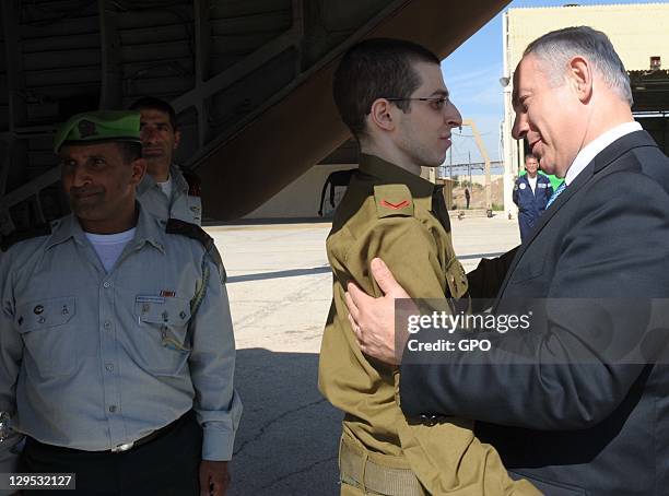 In this handout photo provided by the the Israeli Government Press Office , freed Israeli soldier Gilad Shalit is greeted by Israeli Prime Minister...