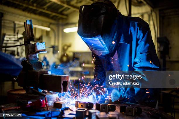 senior man welding farming equipment - in flames i the mask stock pictures, royalty-free photos & images